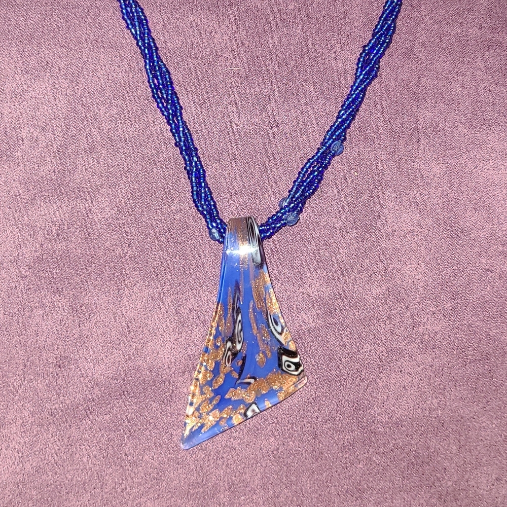 Handmade blue necklace with unique pendant detail